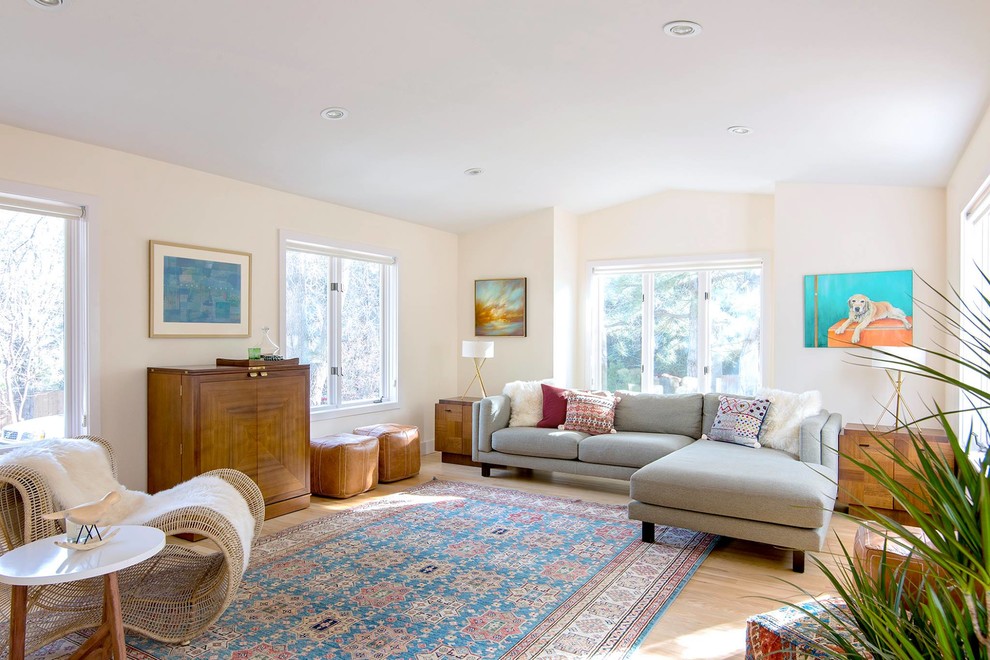 Mid-sized midcentury open concept living room in Denver with beige walls, light hardwood floors, no fireplace and brown floor.