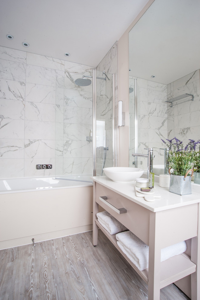 Inspiration for a mid-sized transitional bathroom in Sussex with flat-panel cabinets, beige cabinets, white tile, an open shower, a drop-in tub, a shower/bathtub combo, porcelain tile, grey walls and a console sink.