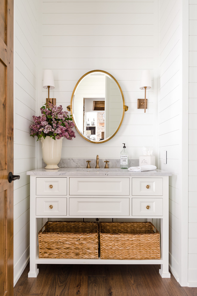 Inspiration for a mid-sized country 3/4 bathroom in Columbus with white cabinets, white walls, dark hardwood floors, an undermount sink, brown floor, grey benchtops and recessed-panel cabinets.
