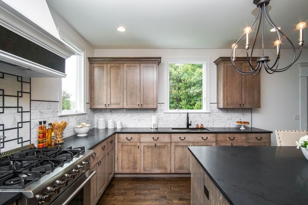 Transitional u-shaped dark wood floor and black floor eat-in kitchen photo in Chicago with an undermount sink, shaker cabinets, granite countertops, white backsplash, ceramic backsplash, stainless steel appliances, an island and black countertops