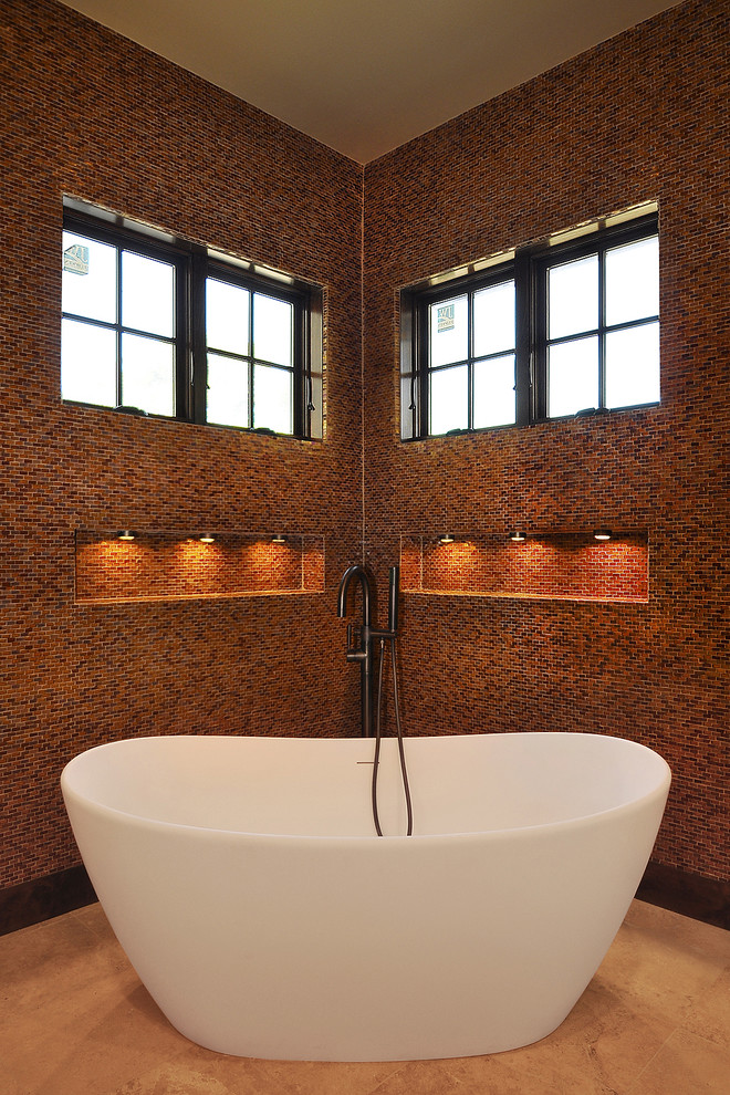 Inspiration for a mid-sized mediterranean master bathroom in Austin with a freestanding tub, red tile, mosaic tile, red walls and travertine floors.