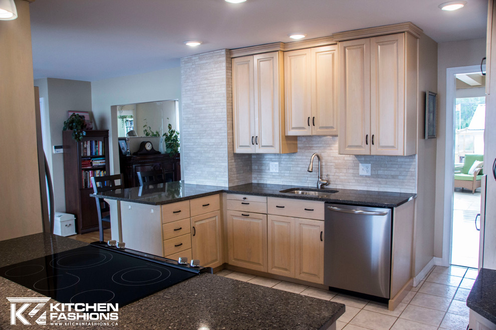 Large trendy u-shaped porcelain tile eat-in kitchen photo with an undermount sink, raised-panel cabinets, light wood cabinets, quartzite countertops, multicolored backsplash, porcelain backsplash, stainless steel appliances and a peninsula