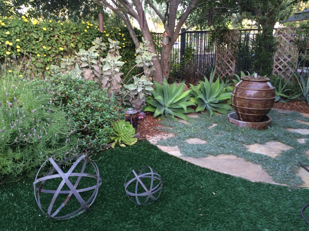 Photo of a mediterranean backyard partial sun garden in San Diego.