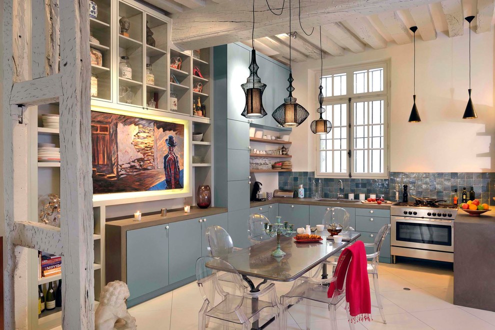 Inspiration for a large transitional kitchen pantry in Nice with an undermount sink, blue cabinets, wood benchtops, blue splashback, matchstick tile splashback, stainless steel appliances, ceramic floors, with island, beige floor and brown benchtop.