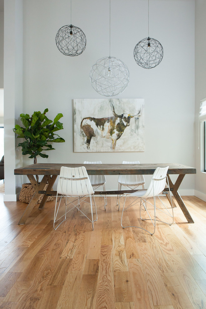 Contemporary dining room in San Francisco with grey walls and light hardwood floors.