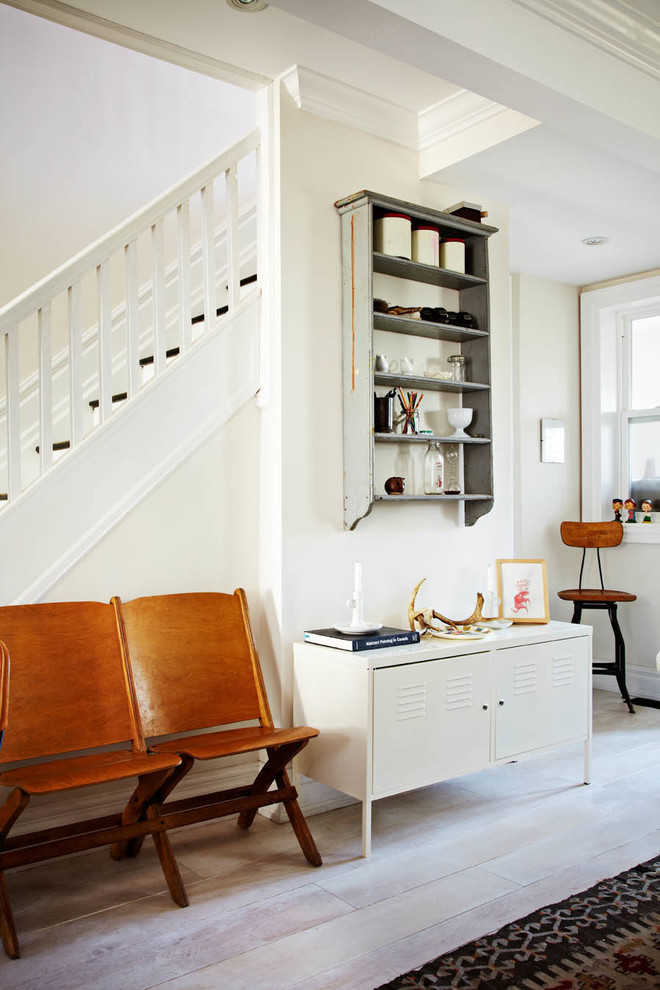 Design ideas for an eclectic entryway in Toronto with white walls.