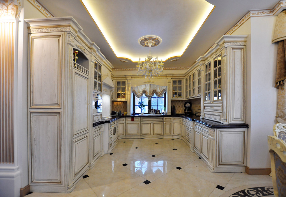 Traditional u-shaped kitchen in Yekaterinburg with glass-front cabinets, beige cabinets, panelled appliances and no island.