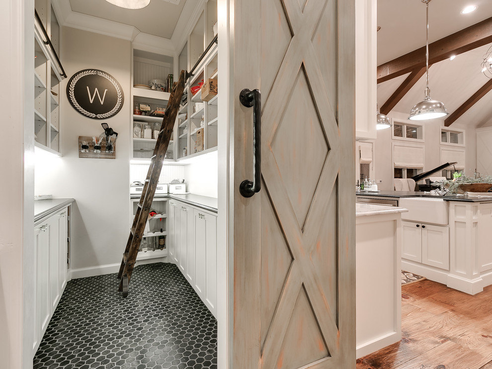 Kitchen pantry - farmhouse black floor kitchen pantry idea in Oklahoma City with shaker cabinets, white cabinets and gray countertops