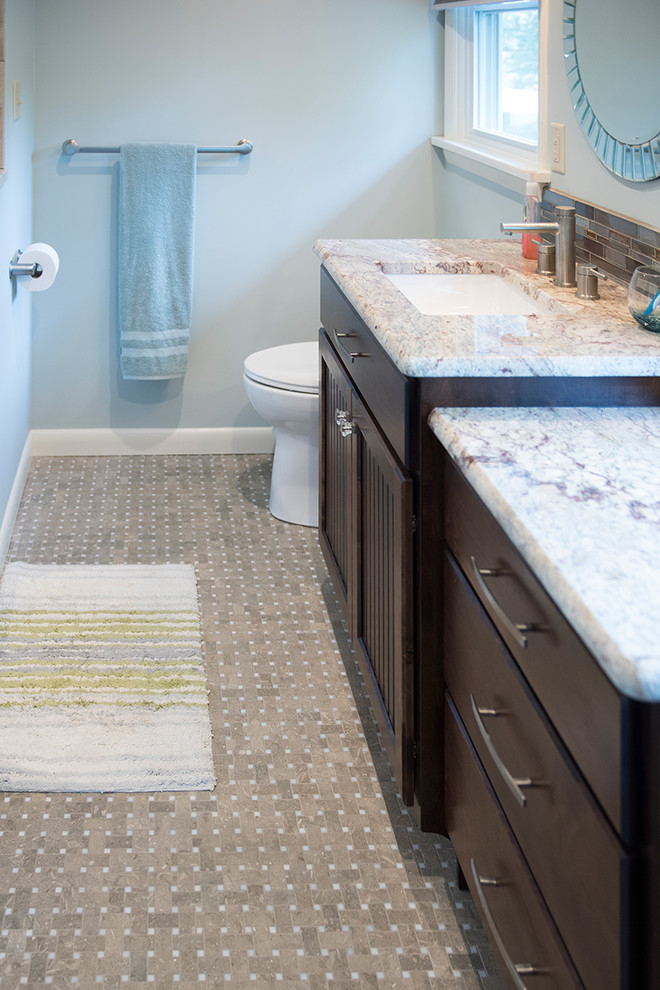 Mid-sized transitional 3/4 brown tile and matchstick tile brown floor bathroom photo with recessed-panel cabinets, dark wood cabinets, a one-piece toilet, gray walls, an undermount sink and granite countertops