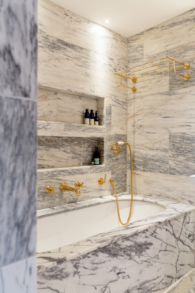 Large eclectic master bathroom in London with an alcove tub, an alcove shower, gray tile, marble, grey walls, marble floors, tile benchtops, grey floor, an open shower and grey benchtops.