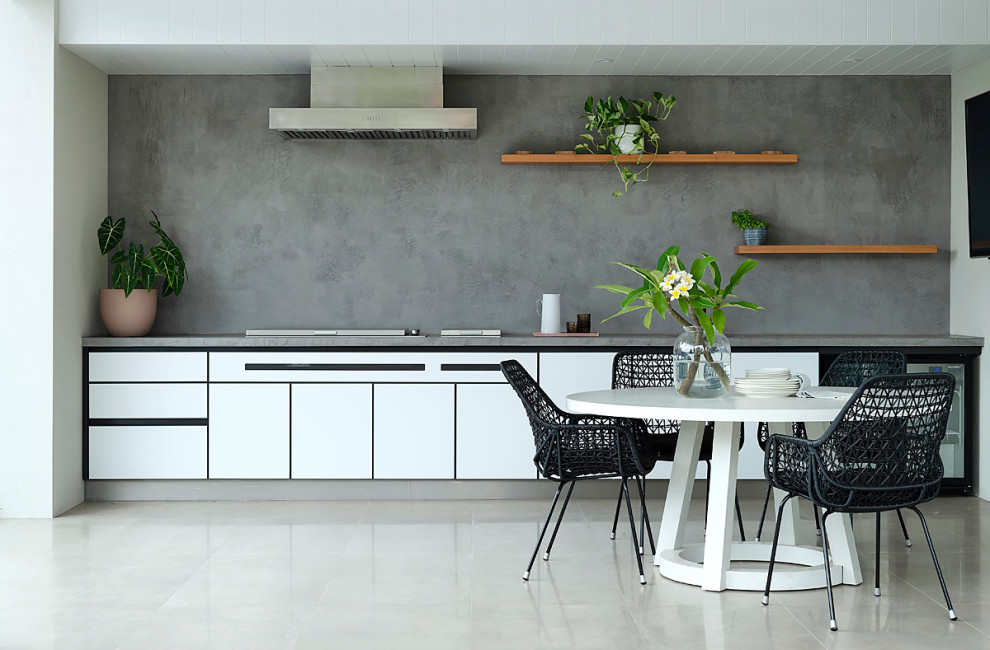 Design ideas for a mid-sized contemporary single-wall kitchen in Perth with flat-panel cabinets, white cabinets, grey splashback, panelled appliances, no island, grey floor and grey benchtop.