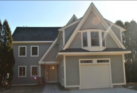 This is an example of a mid-sized arts and crafts two-storey grey exterior in Providence with wood siding.