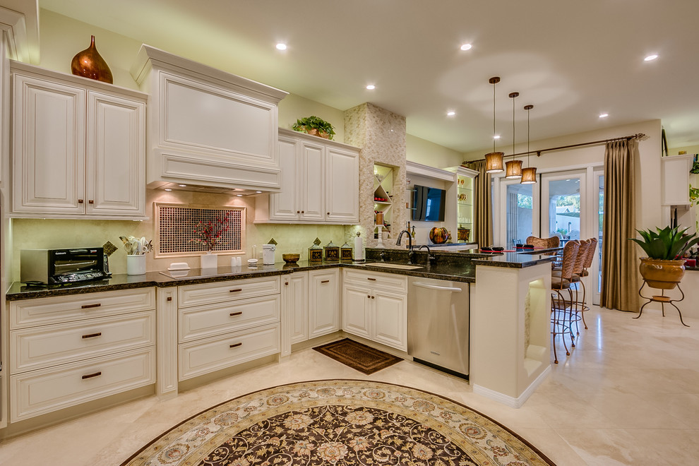 Inspiration for a kitchen remodel in Phoenix with beige cabinets, granite countertops and stainless steel appliances
