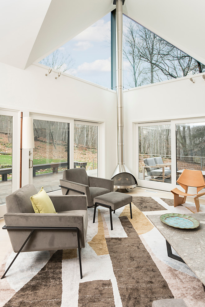 Photo of a scandinavian sunroom in New York with a wood stove.