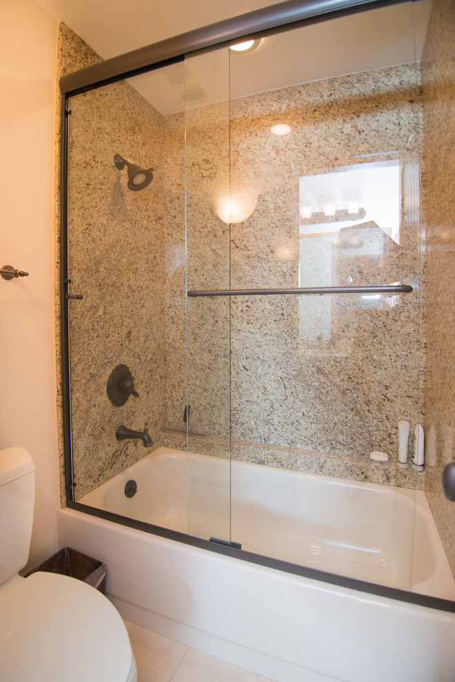 This is an example of a mid-sized traditional master bathroom in Denver with beige tile, beige walls, an undermount sink, beige floor, a hinged shower door, a drop-in tub, a shower/bathtub combo, a one-piece toilet and ceramic floors.