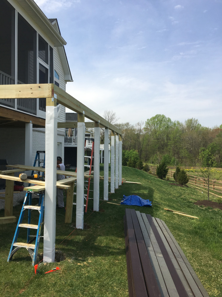 Example of a large backyard second story cable railing deck design in Baltimore