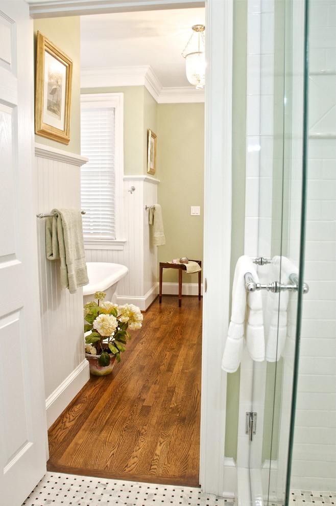 Design ideas for a mid-sized traditional master bathroom in Other with an undermount sink, beaded inset cabinets, white cabinets, marble benchtops, a freestanding tub, a corner shower, white tile, subway tile, green walls and dark hardwood floors.