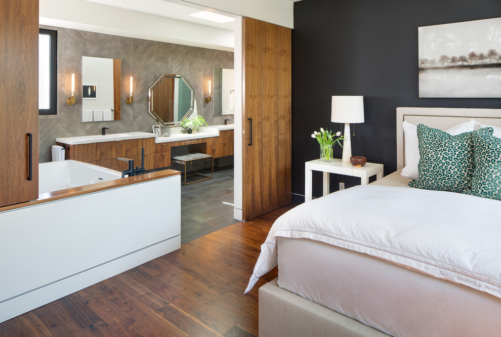 This is an example of a mid-sized contemporary master bedroom in San Diego with white walls and dark hardwood floors.