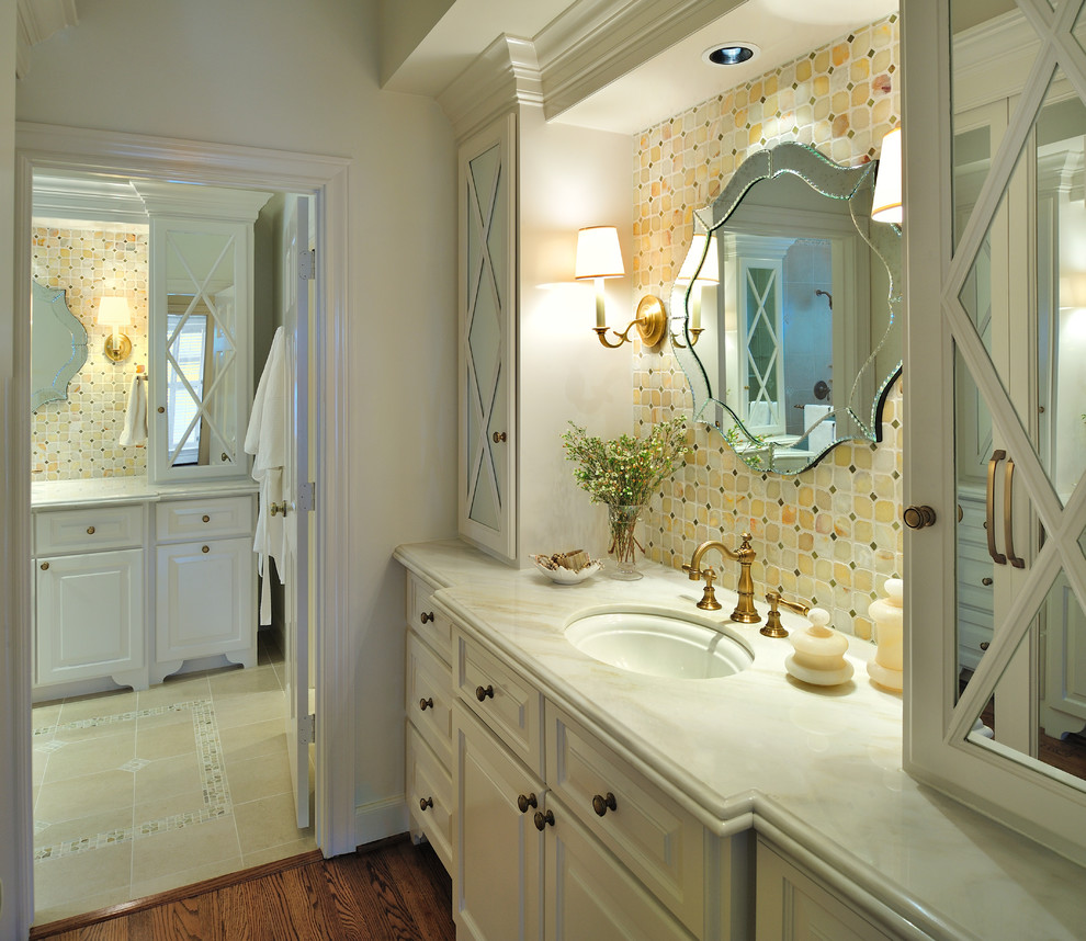 This is an example of a mid-sized traditional master bathroom in Houston with an undermount sink, raised-panel cabinets, light wood cabinets, marble benchtops, an open shower, beige tile, stone tile and travertine floors.