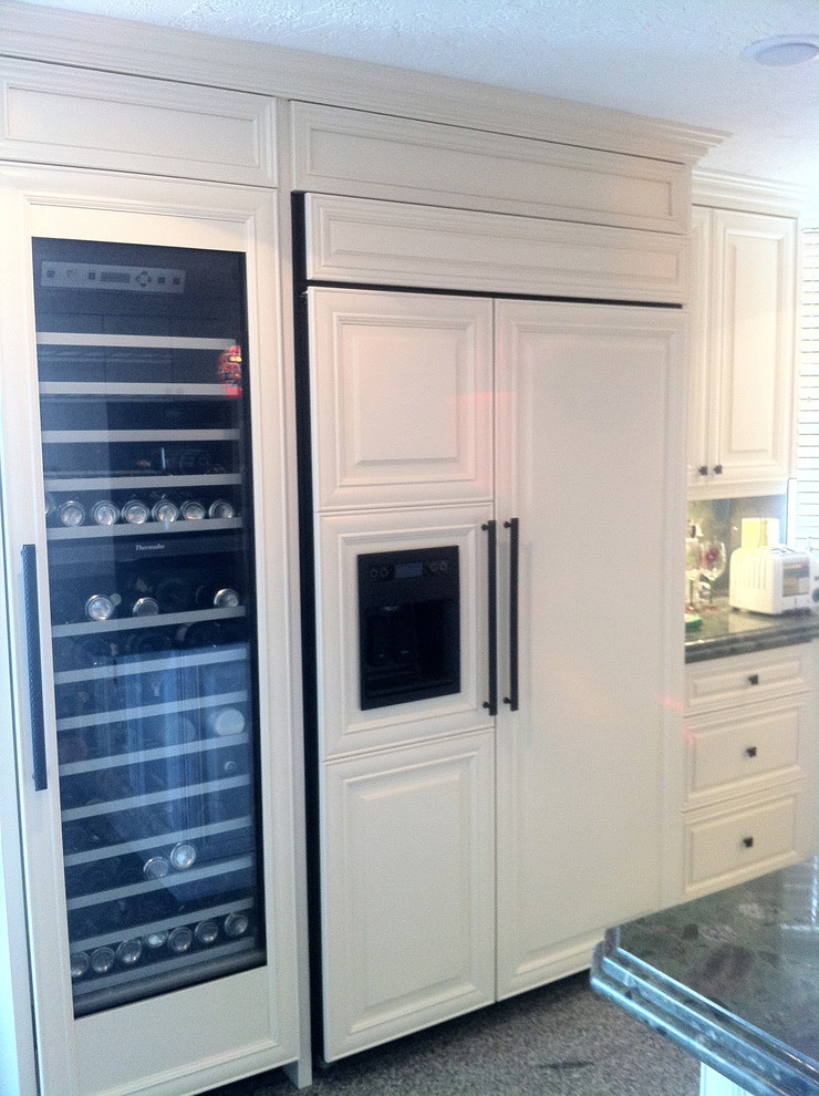 Large transitional u-shaped terrazzo floor and black floor open concept kitchen photo in Miami with a single-bowl sink, raised-panel cabinets, white cabinets, granite countertops, multicolored backsplash, stone tile backsplash, stainless steel appliances and an island