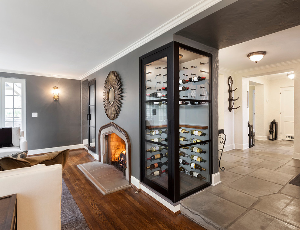 Photo of a large transitional wine cellar in Detroit with medium hardwood floors, display racks and brown floor.