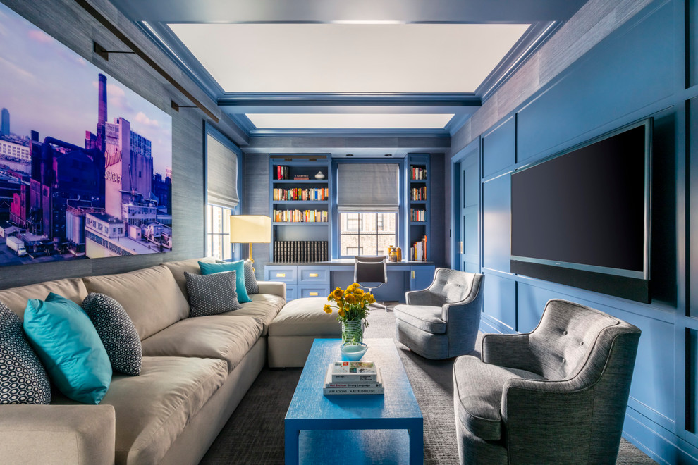This is an example of a transitional family room in New York with blue walls and carpet.