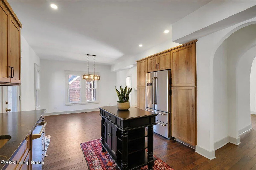 Inspiration for a mid-sized transitional l-shaped medium tone wood floor kitchen remodel with an undermount sink, shaker cabinets, light wood cabinets and an island