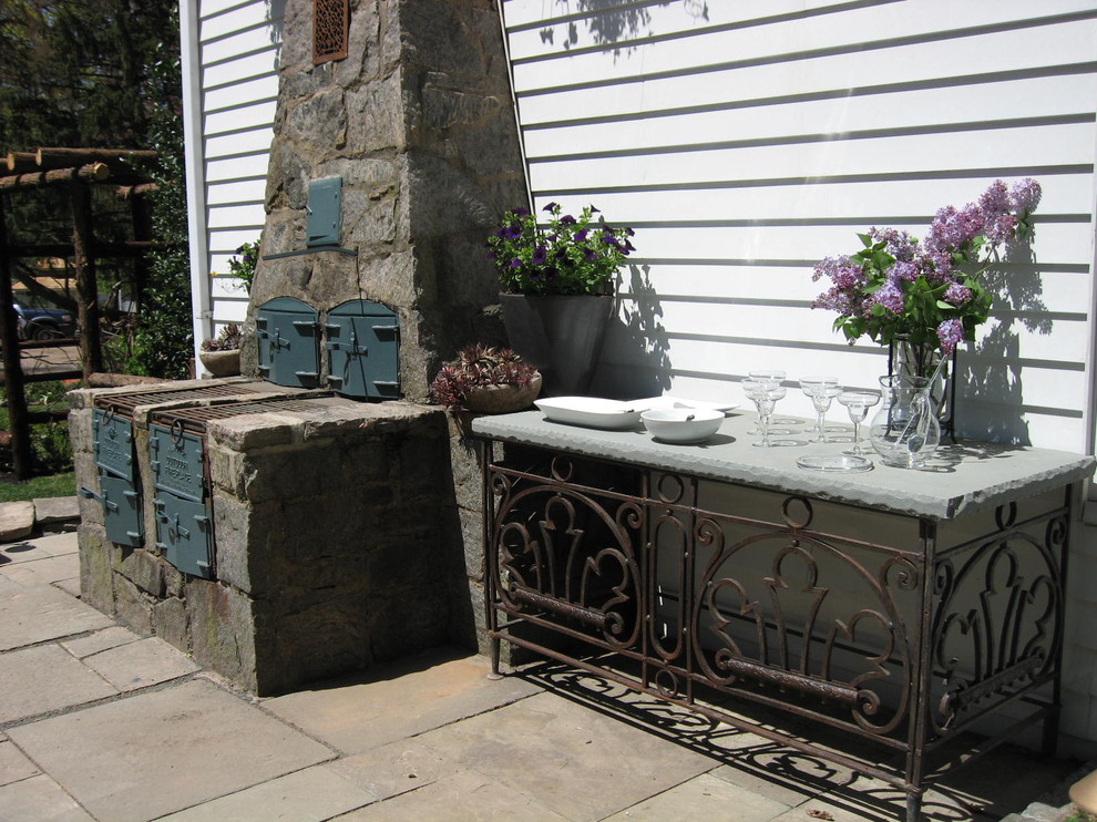 Inspiration for a small traditional backyard patio in Newark with natural stone pavers.