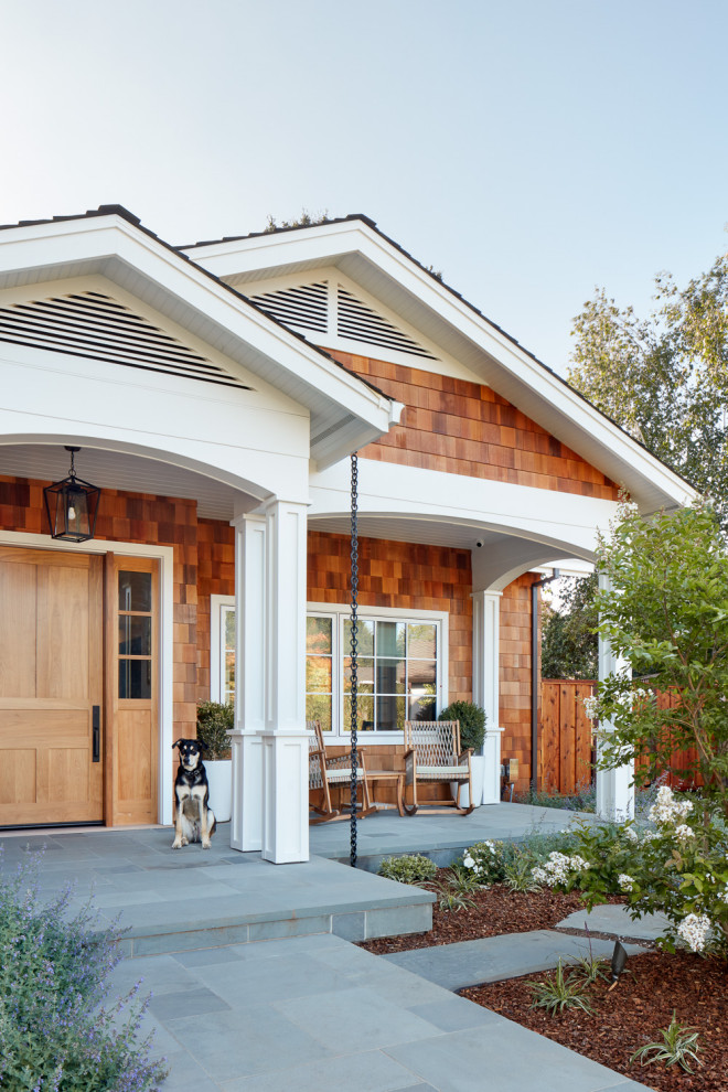 Mid-sized transitional stone front porch photo in San Francisco with a roof extension