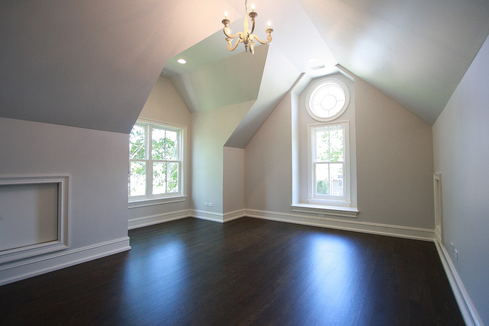 This is an example of a transitional guest bedroom in Chicago with beige walls, dark hardwood floors and no fireplace.