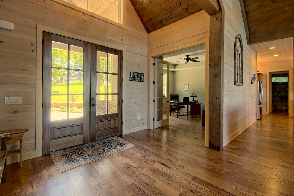 Photo of a large arts and crafts front door in Atlanta with beige walls, medium hardwood floors, a double front door, a dark wood front door and brown floor.