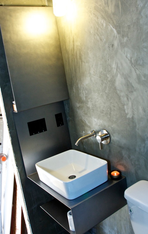 Small industrial bathroom in Portland with a vessel sink, open cabinets and an open shower.