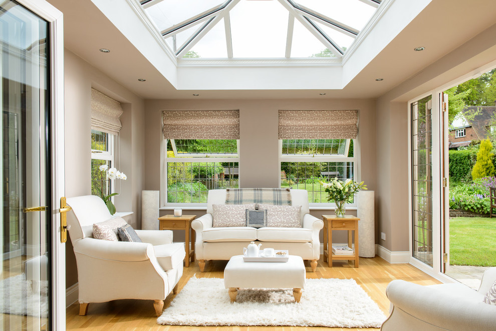 Traditional sunroom in Other with light hardwood floors, a skylight and beige floor.