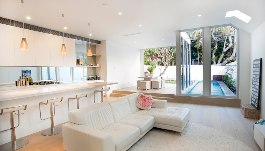 Inspiration for a mid-sized contemporary open concept living room in Sydney with white walls and bamboo floors.