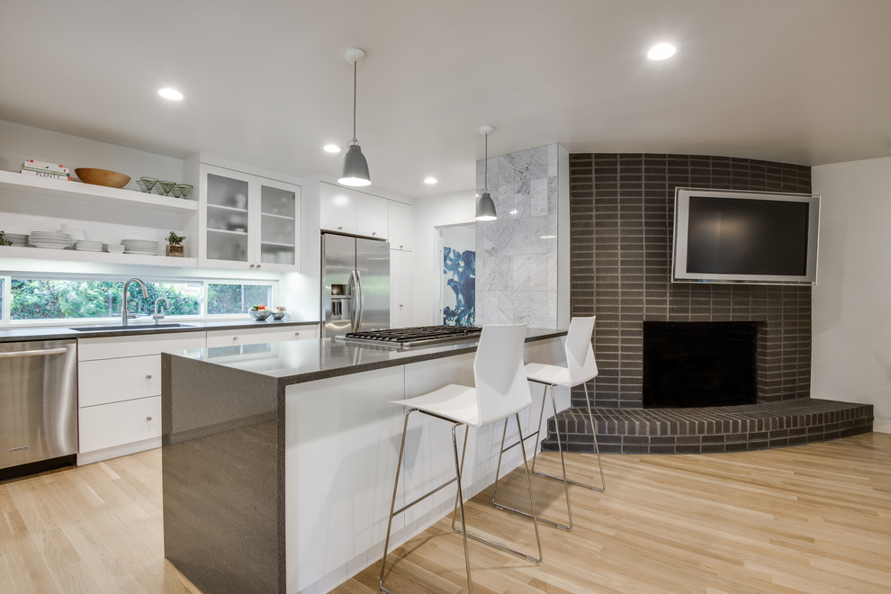 Design ideas for a mid-sized scandinavian galley open plan kitchen in Dallas with an undermount sink, open cabinets, white cabinets, stainless steel appliances, light hardwood floors, with island, quartz benchtops, grey splashback and stone tile splashback.