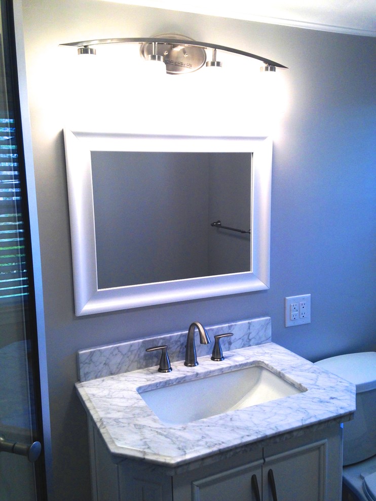 Small transitional 3/4 white tile and porcelain tile porcelain tile home design photo with an integrated sink, a two-piece toilet and white walls