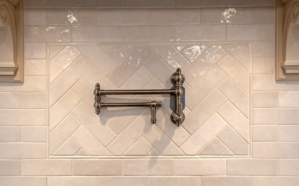 Example of a transitional eat-in kitchen design with shaker cabinets, beige cabinets, quartz countertops, white backsplash, cement tile backsplash, stainless steel appliances, an island and white countertops