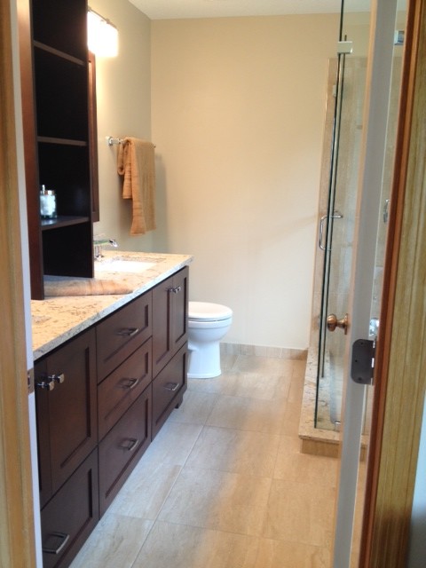 Photo of a mid-sized transitional master bathroom in Minneapolis with shaker cabinets, dark wood cabinets, beige tile, ceramic tile, beige walls, ceramic floors, an undermount sink and engineered quartz benchtops.