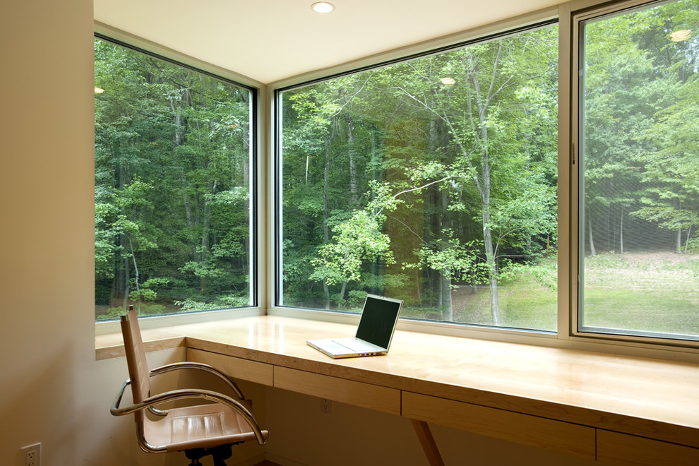 This is an example of a contemporary home office in DC Metro with a built-in desk.
