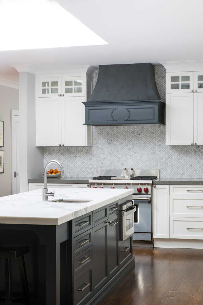 Mid-sized transitional l-shaped kitchen in San Francisco with with island, shaker cabinets, white cabinets, soapstone benchtops, grey splashback, mosaic tile splashback, stainless steel appliances, dark hardwood floors, brown floor and a farmhouse sink.