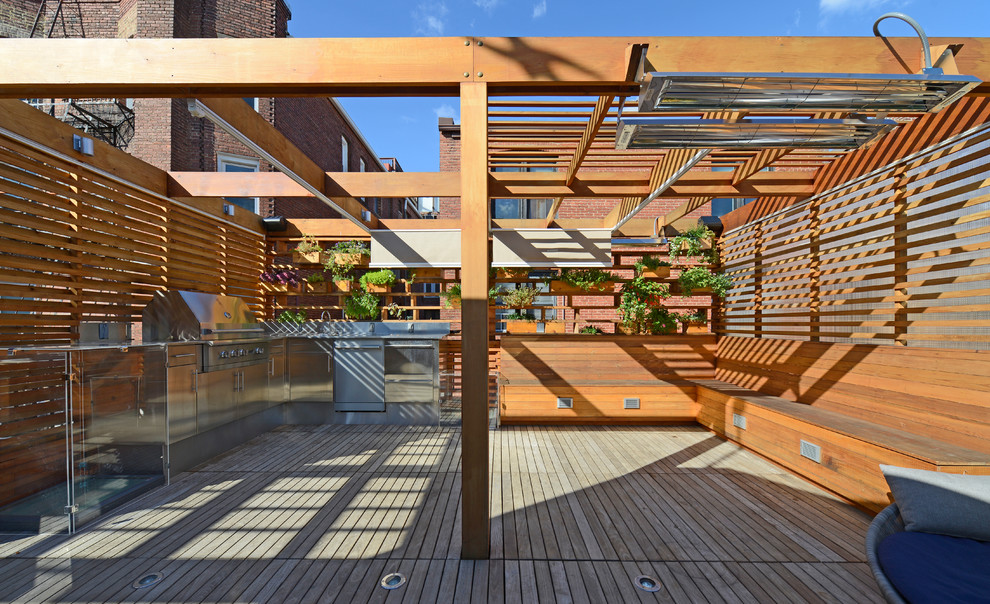 Photo of a small modern rooftop deck in DC Metro with a water feature and a pergola.