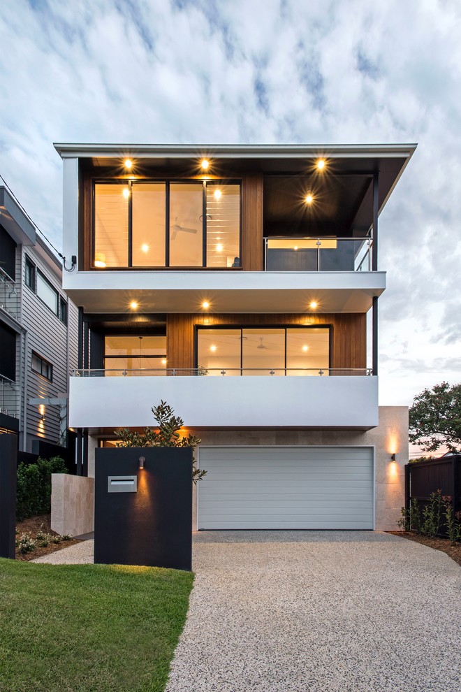 Contemporary three-storey beige house exterior in Brisbane with mixed siding and a flat roof.
