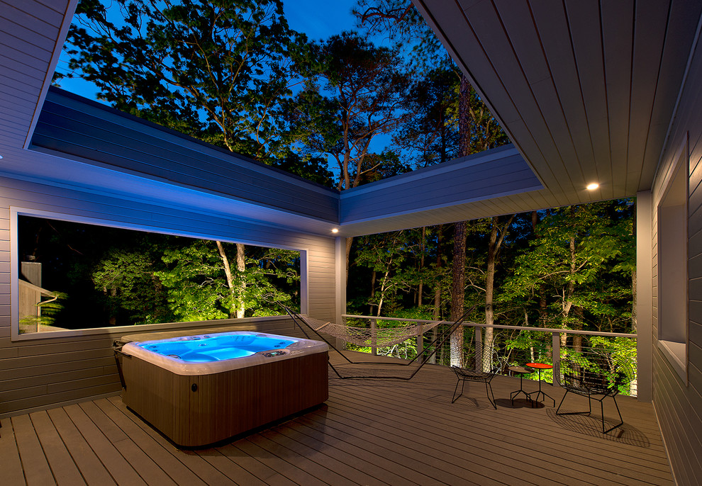 Design ideas for a large modern backyard deck in Other with a roof extension.