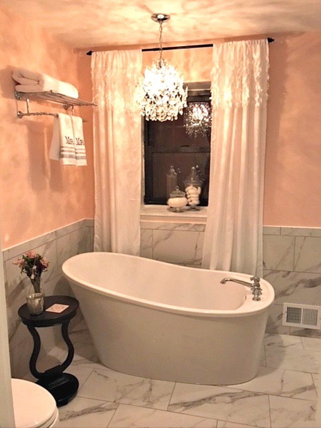 Inspiration for a small traditional master bathroom in Other with open cabinets, a freestanding tub, a corner shower, white tile, stone tile, yellow walls, marble floors, a pedestal sink, solid surface benchtops, white floor and a hinged shower door.