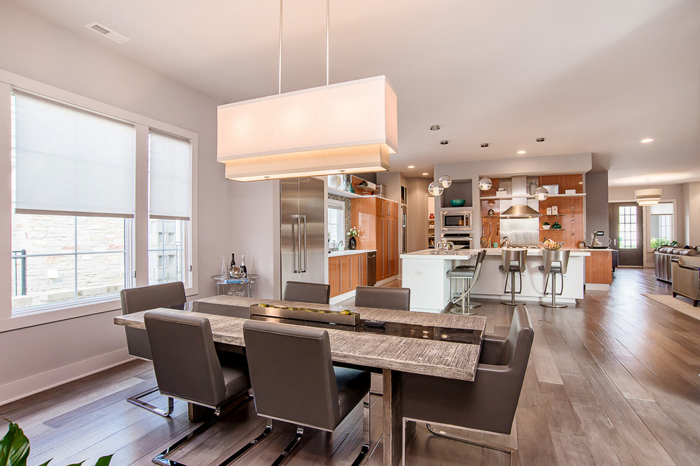 Contemporary kitchen/dining combo in Indianapolis with grey walls and light hardwood floors.