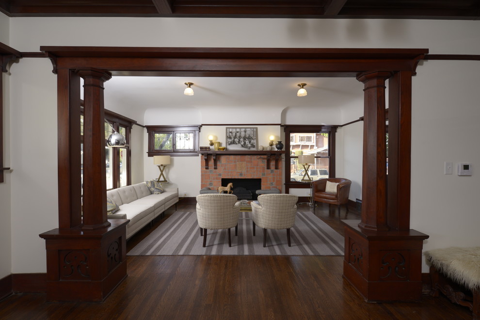 Photo of a large arts and crafts formal open concept living room in Los Angeles with no tv, white walls, dark hardwood floors, a standard fireplace and a tile fireplace surround.