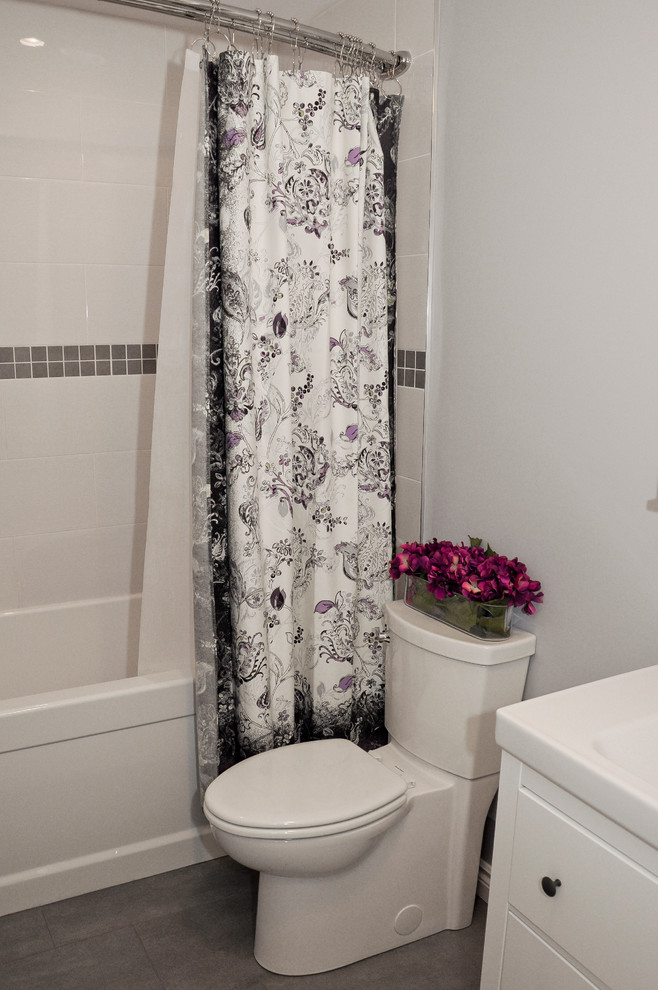 Inspiration for a small transitional master gray tile and porcelain tile porcelain tile home design remodel in Ottawa with shaker cabinets, white cabinets, a two-piece toilet, gray walls, an integrated sink and solid surface countertops