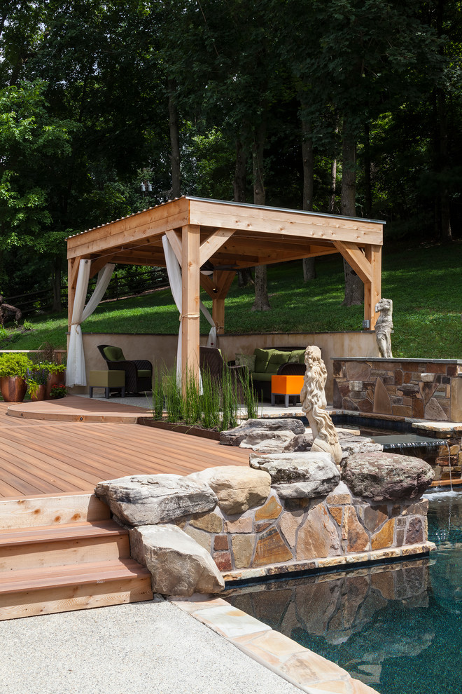 Design ideas for a large modern backyard patio in Baltimore with a gazebo/cabana, a water feature and decking.