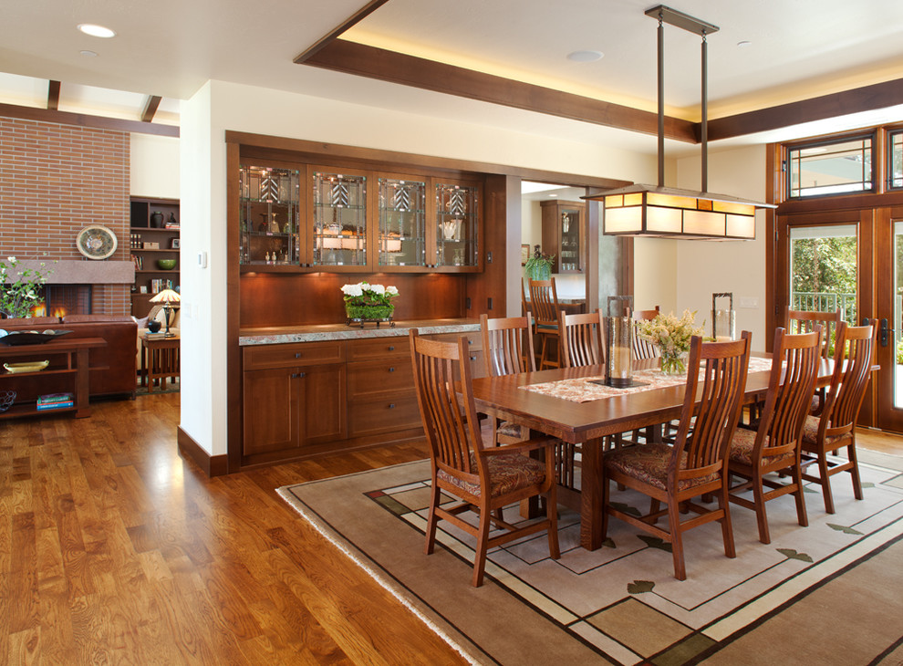 Photo of a mid-sized arts and crafts open plan dining in San Diego with white walls, medium hardwood floors and no fireplace.