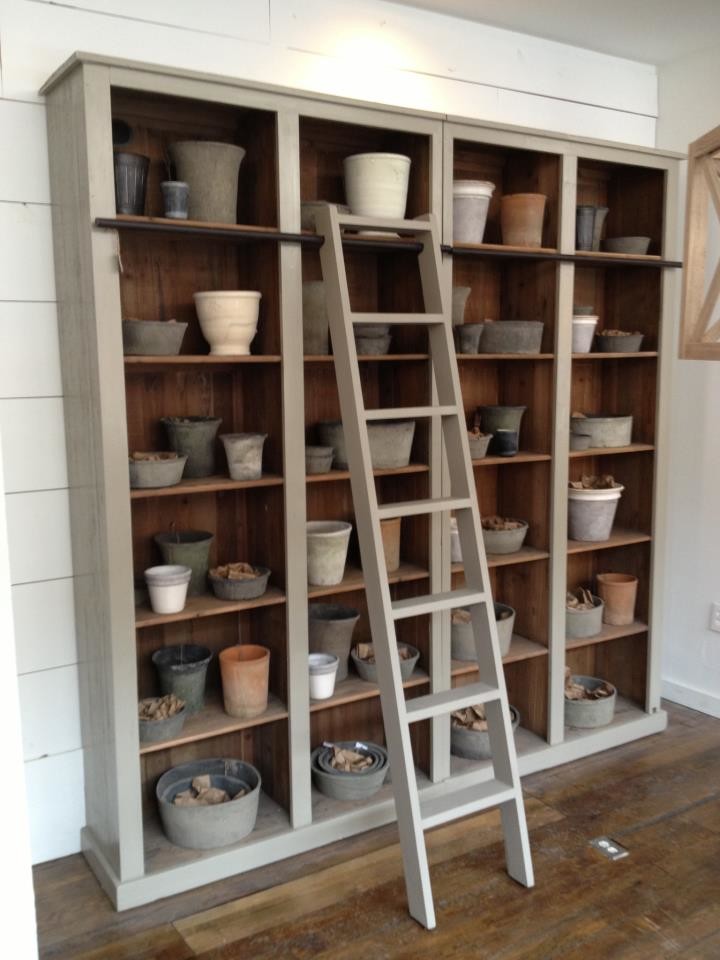 Hallway - small transitional medium tone wood floor and brown floor hallway idea in Columbus with white walls